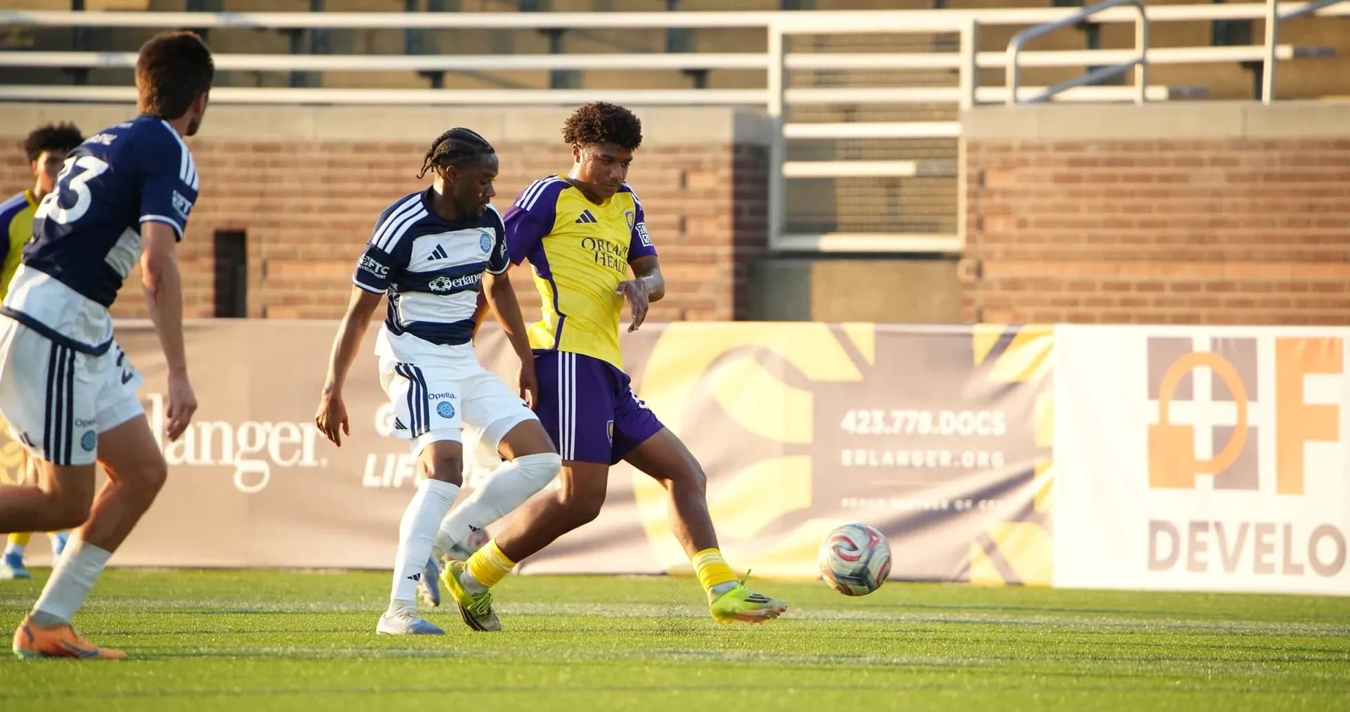 Two players competing for the ball in football match