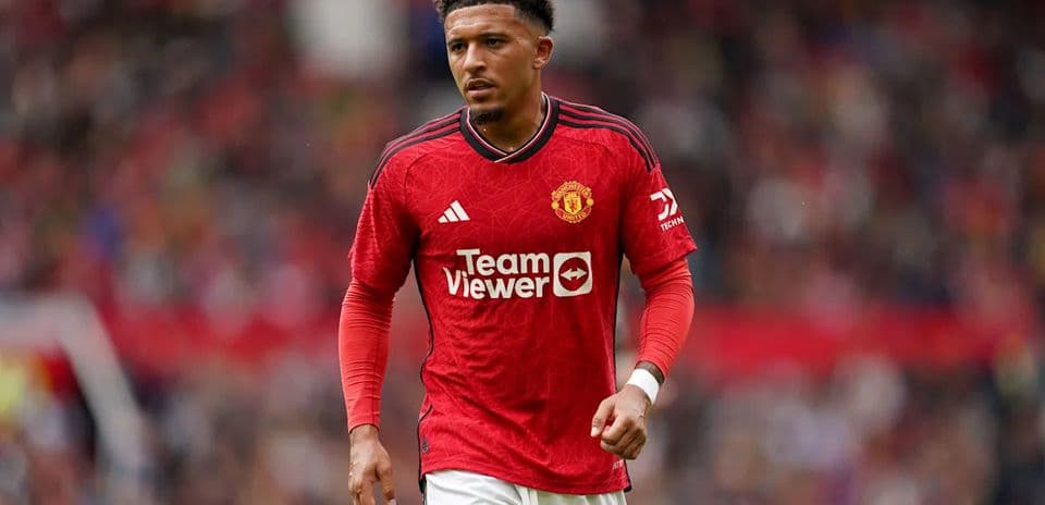 Player walking on the pitch in Manchester United kit