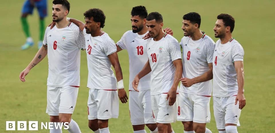 Iranian football players celebrating together on field