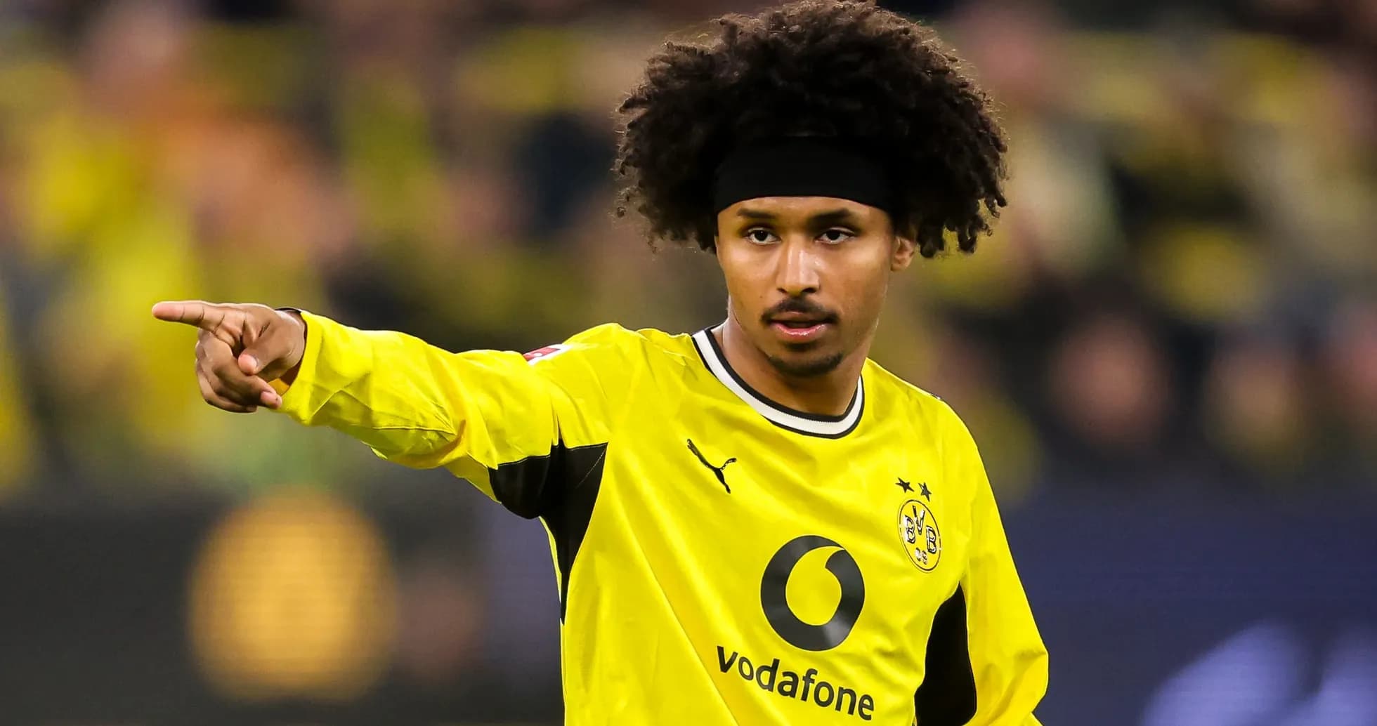 Player pointing during match in yellow jersey