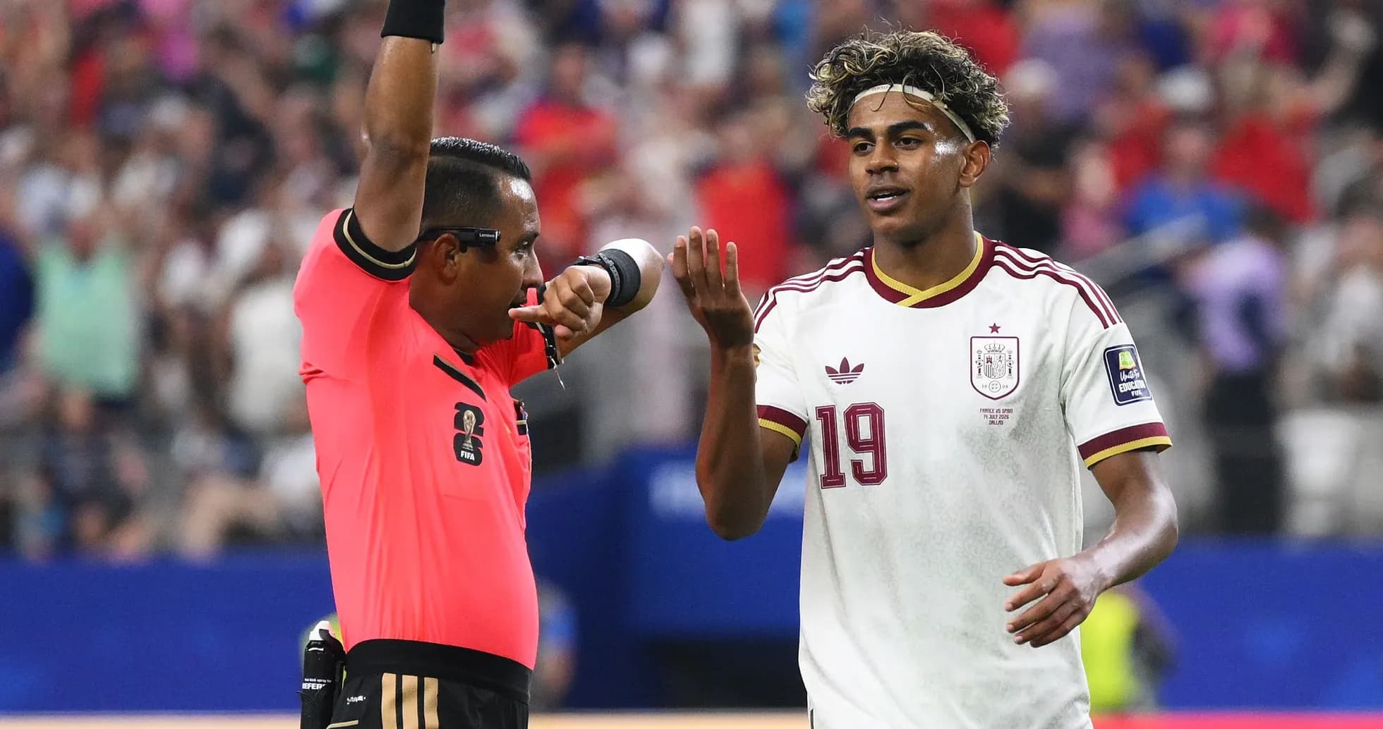 Referee issuing a yellow card to player 19