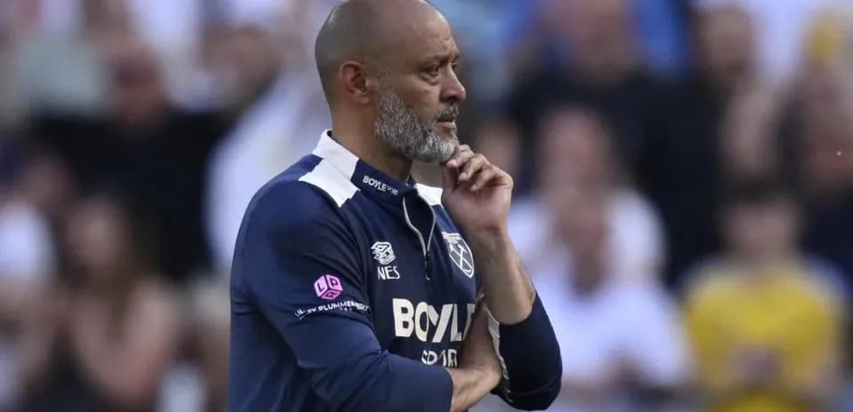 Manager contemplating during a match on sidelines