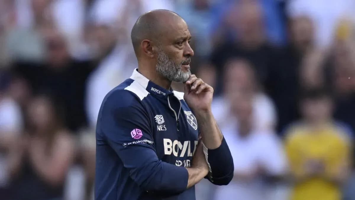 Manager contemplating during a match on sidelines