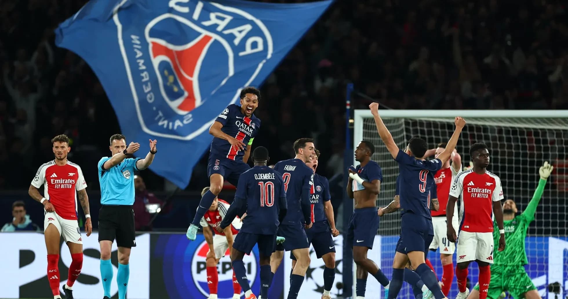 Players celebrating PSG goal against Arsenal