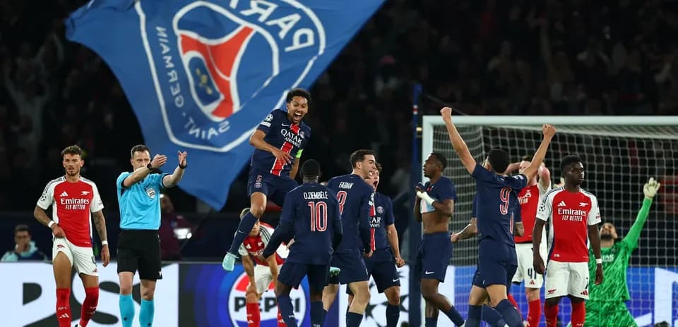 Players celebrating PSG goal against Arsenal