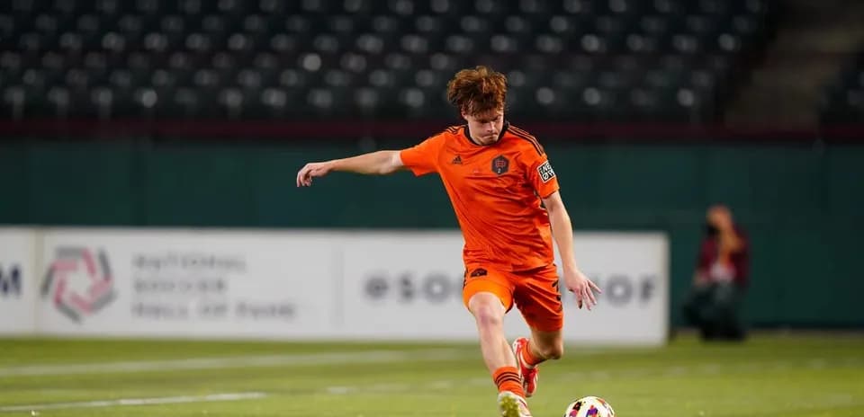 Player kicking ball during MLS Next Pro match
