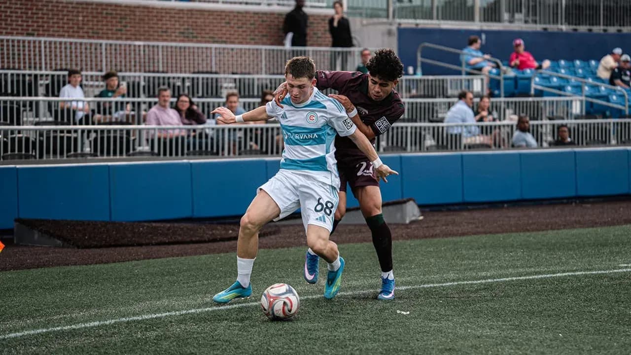 Player tackling opponent during MLS Next Pro match