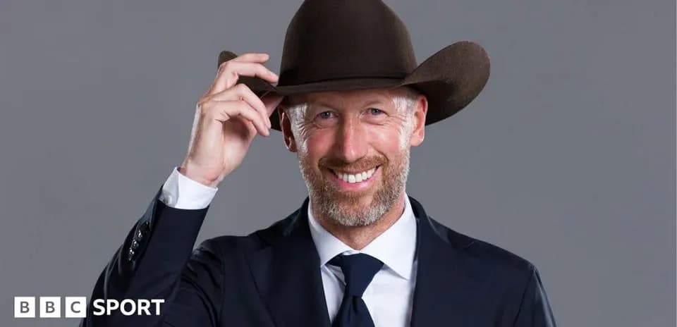 Man in a suit adjusting his cowboy hat