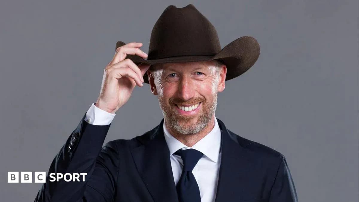 Man in a suit adjusting his cowboy hat