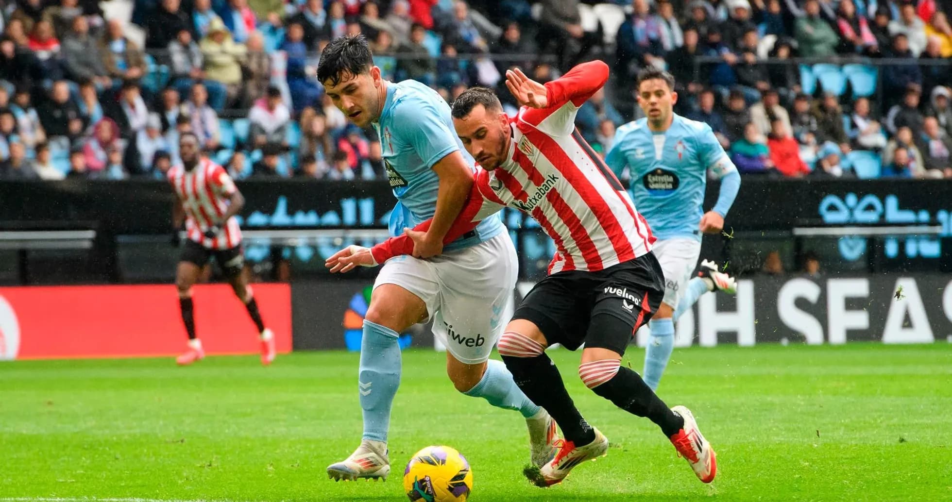 Athletic Club player tackling Celta Vigo opponent