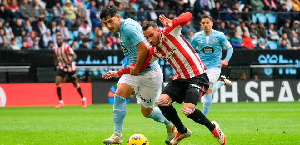 Athletic Club player tackling Celta Vigo opponent