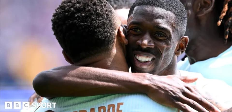 Players celebrating with an embrace after a goal