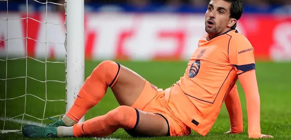 Player sitting beside goal post during match