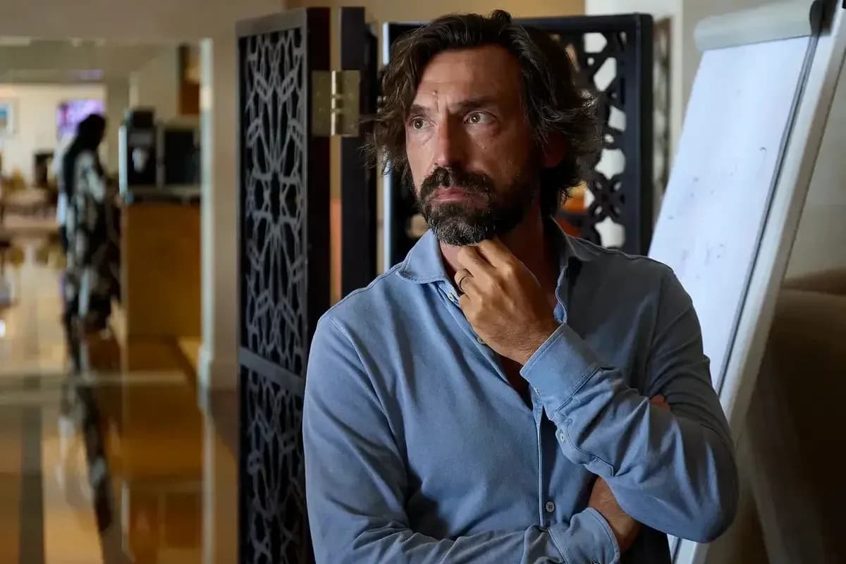Man in blue shirt with thoughtful expression indoors