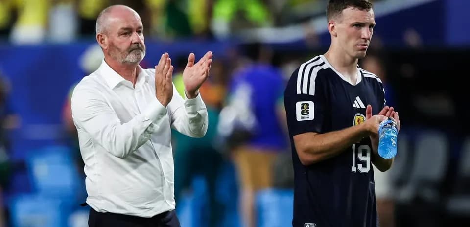 Manager and player applauding after the match