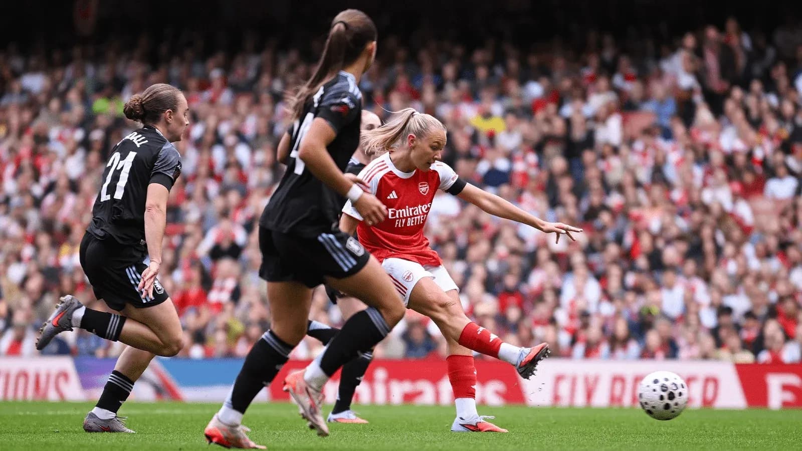 Arsenal player shooting on goal during match