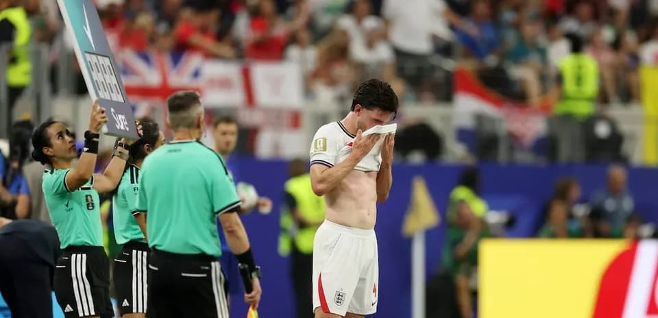Player leaving field, holding shirt to face