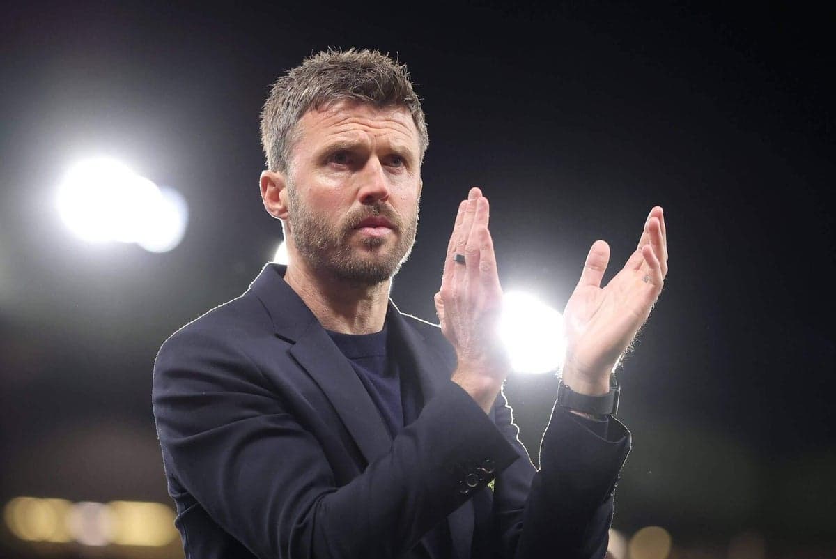 Coach applauding in front of stadium lights