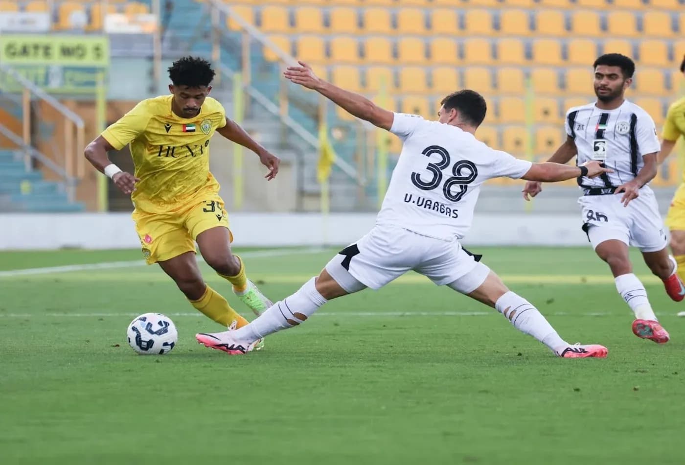 Player dribbling past opponent during U23 match