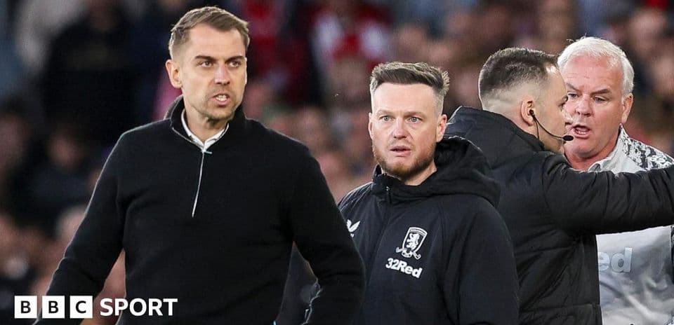 Coaches discussing during a tense match situation