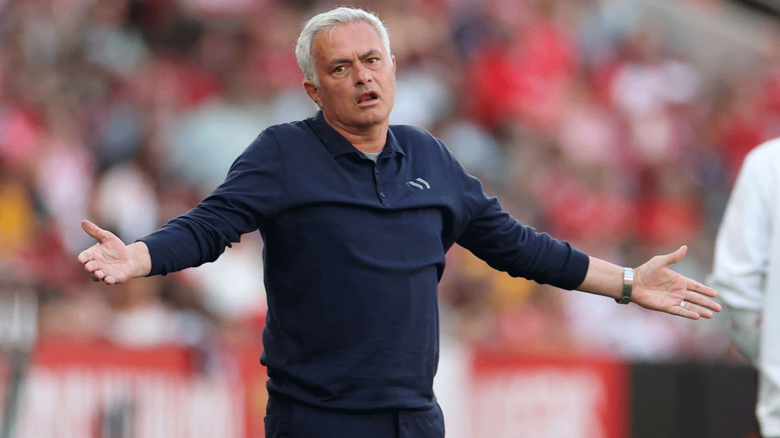 Coach gesturing during a match on the sidelines