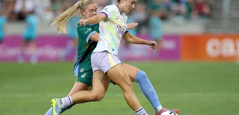 Orlando Pride player dribbling past opponent