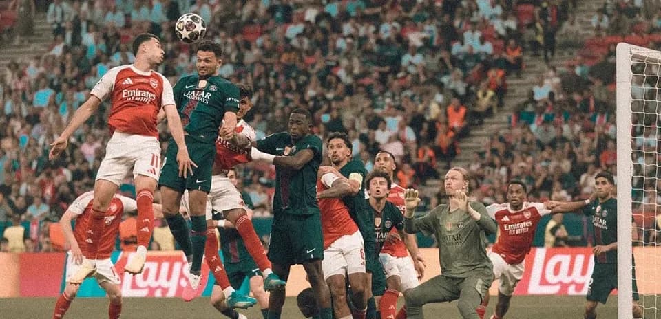 Players contesting a high ball during corner kick