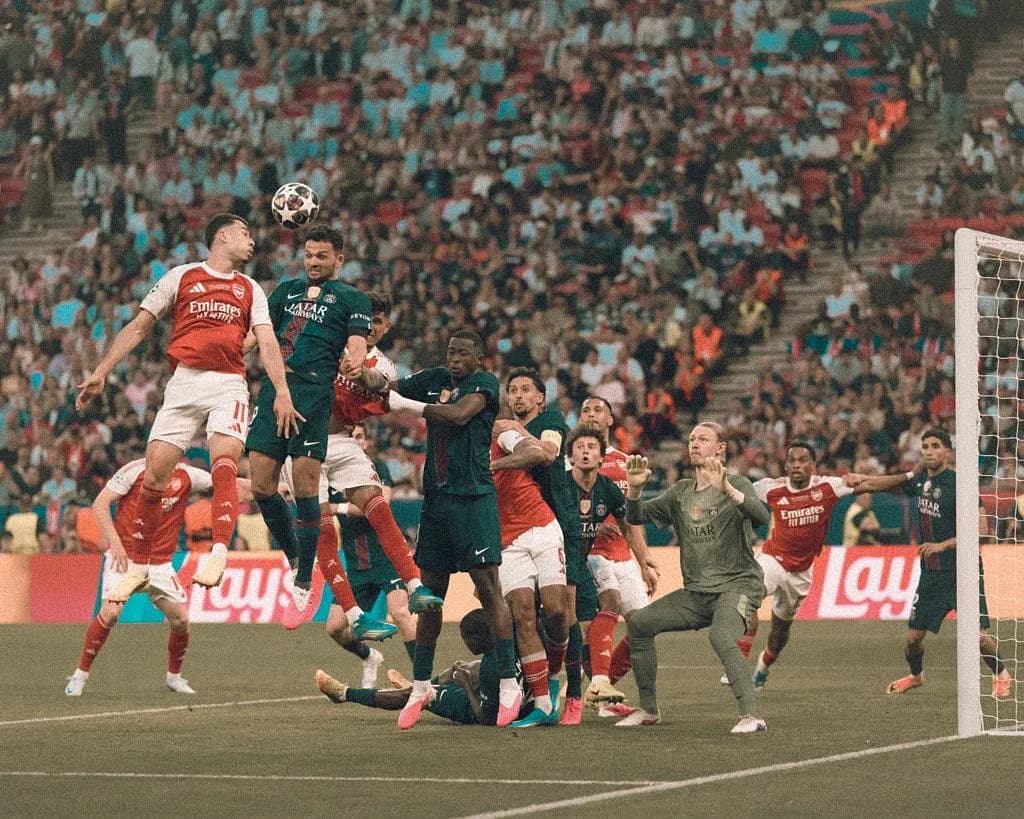 Players contesting a high ball during corner kick