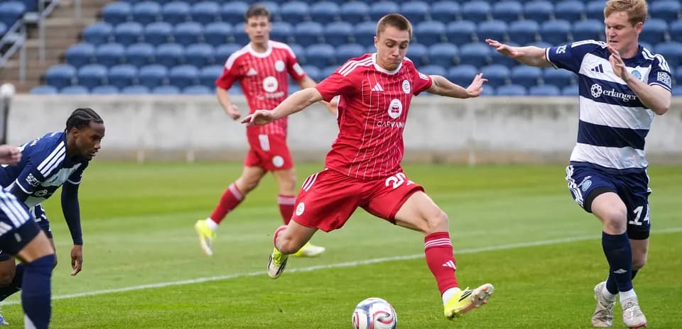 Player dribbling the ball during New England II match