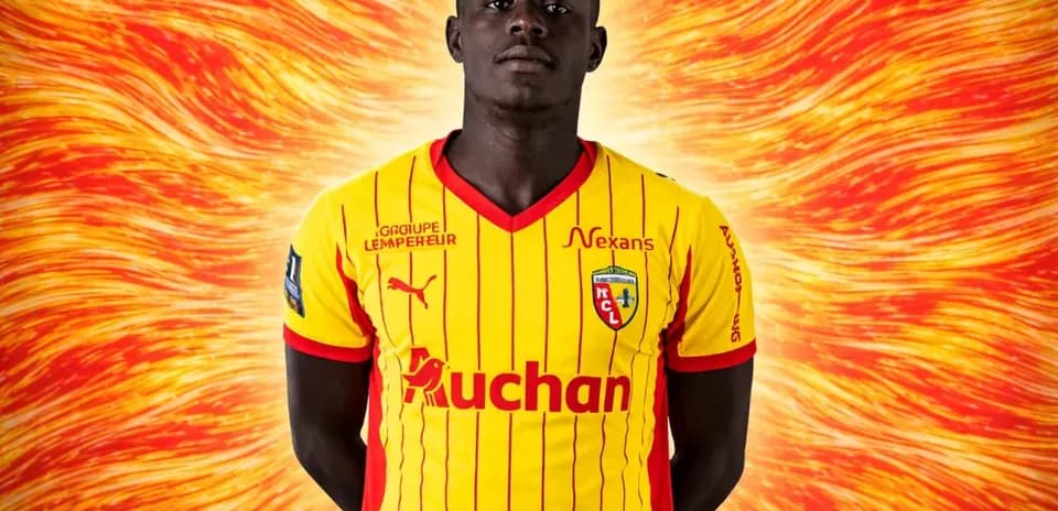 Player in yellow and red jersey with logo