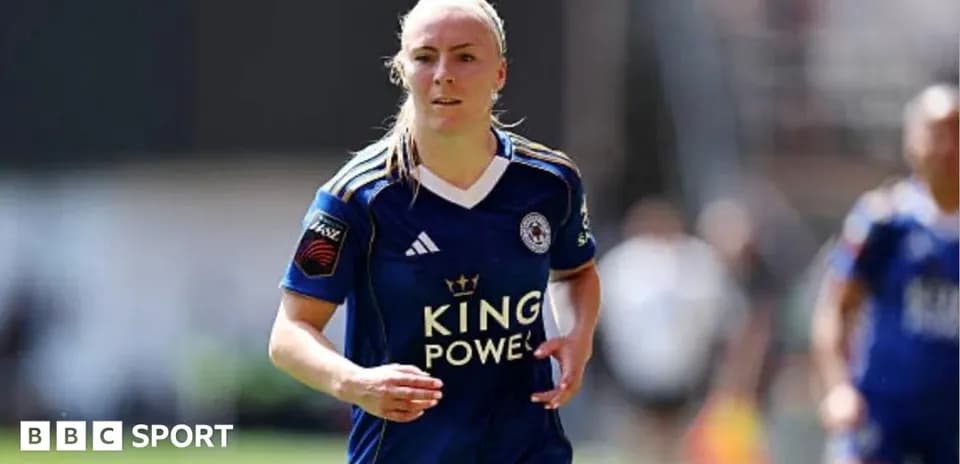 Female player in blue kit running on pitch