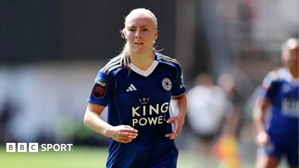 Female player in blue kit running on pitch