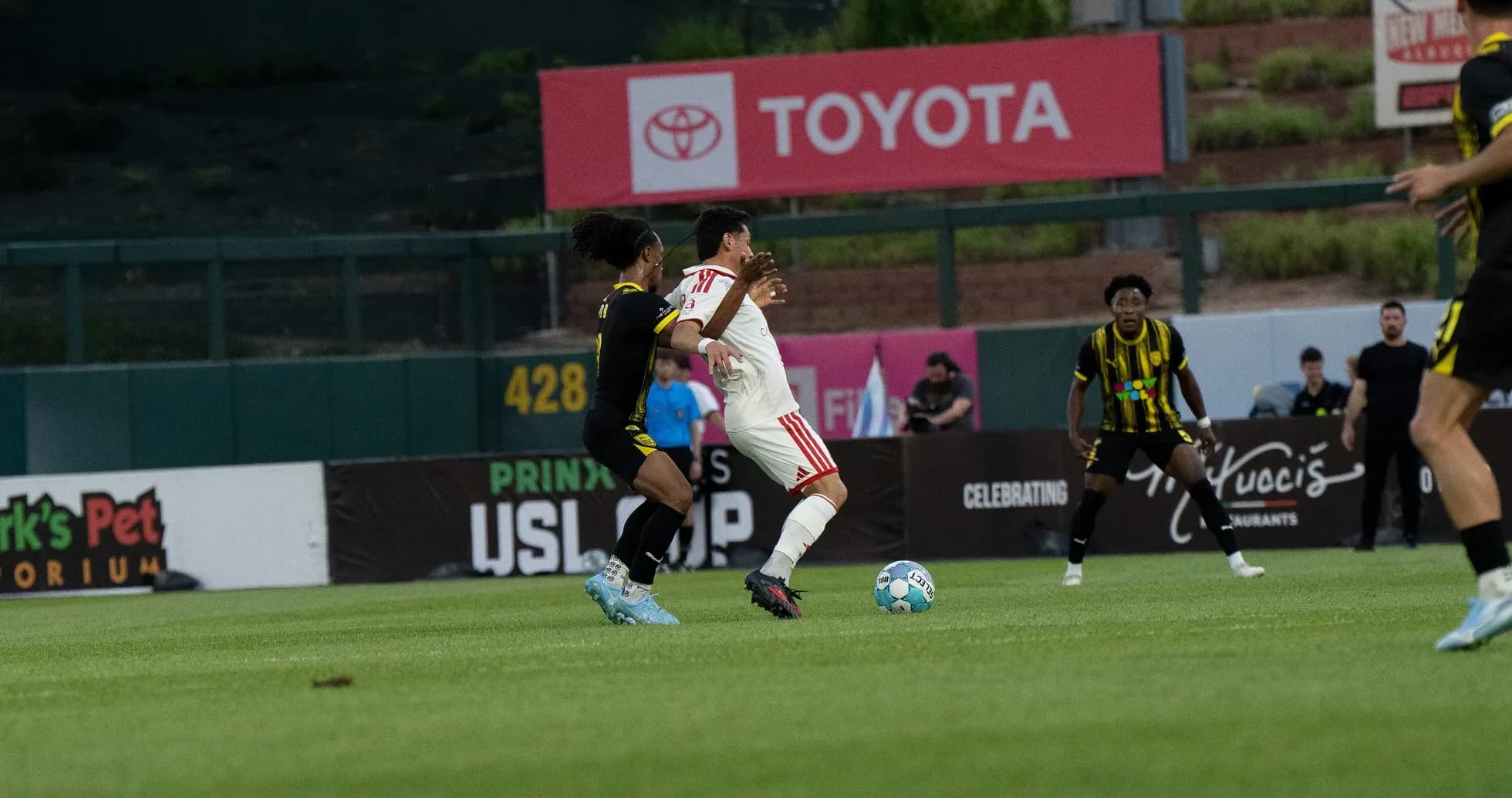 Player tackling opponent during USL match