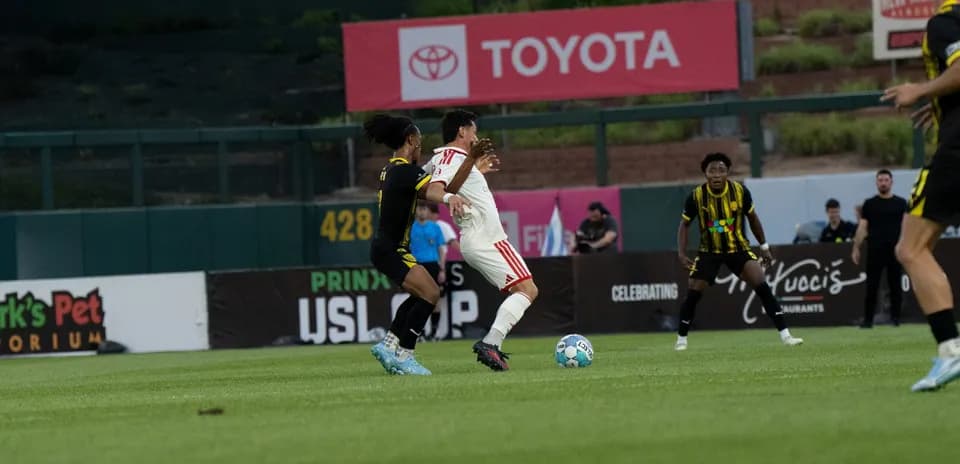 Player tackling opponent during USL match