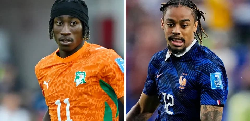 Two soccer players in national team jerseys