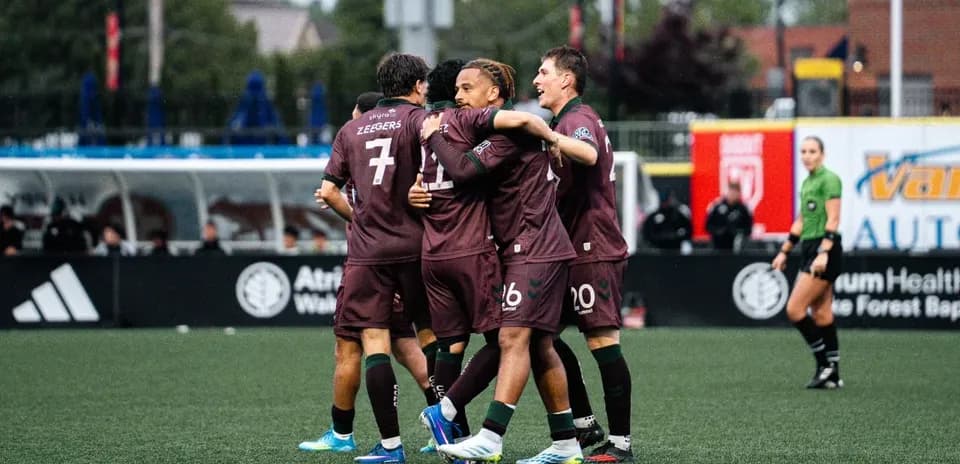 Players celebrating a goal during match