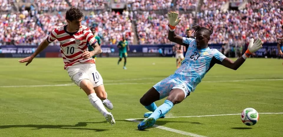 USA player attempting to score against Paraguay goalkeeper