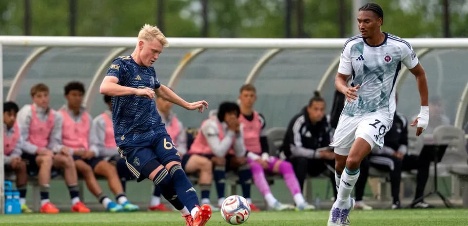 New England II player passing the ball during match