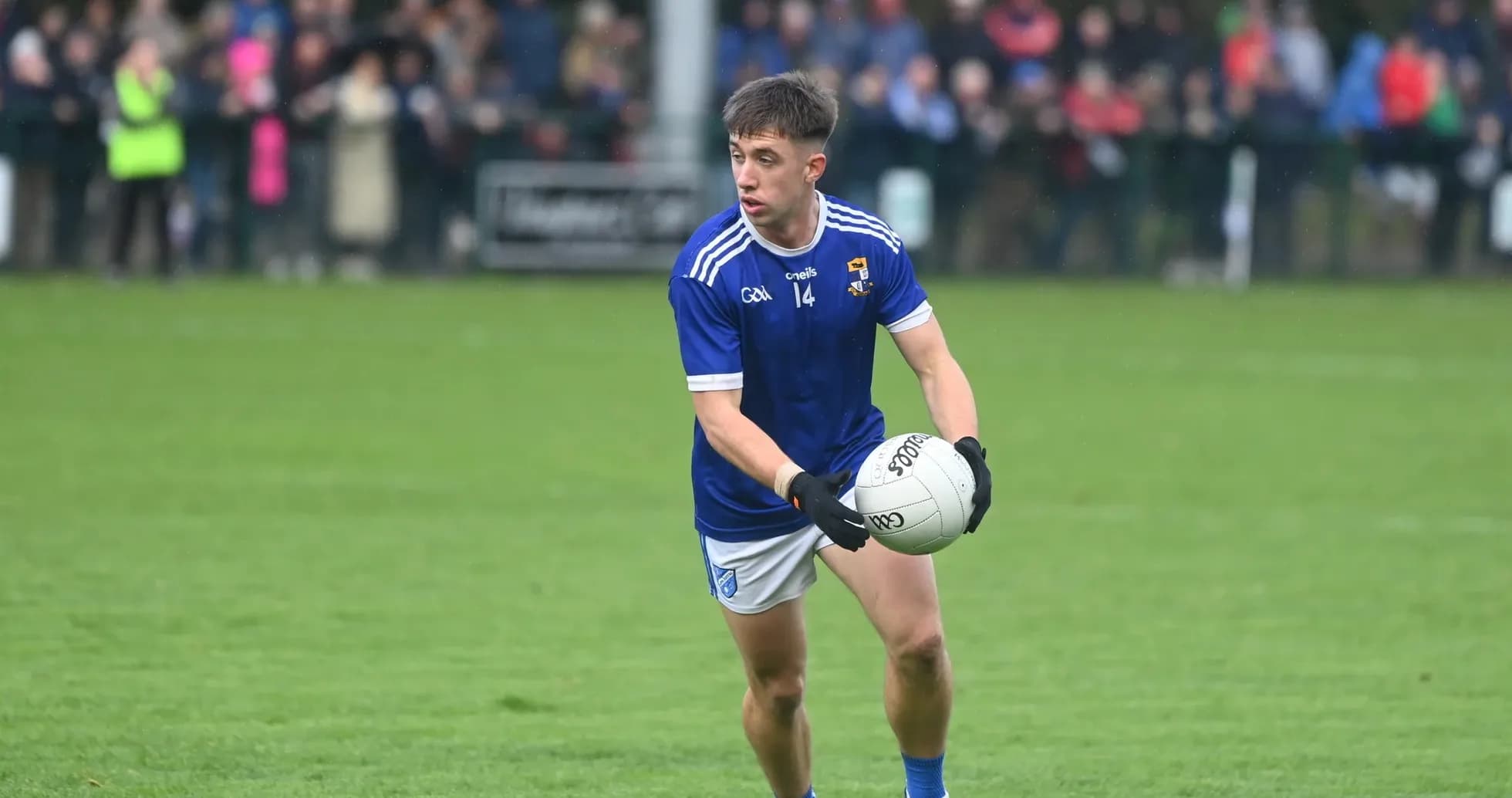 Player in blue jersey holding a football