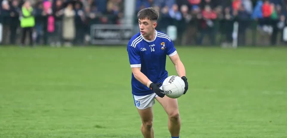 Player in blue jersey holding a football