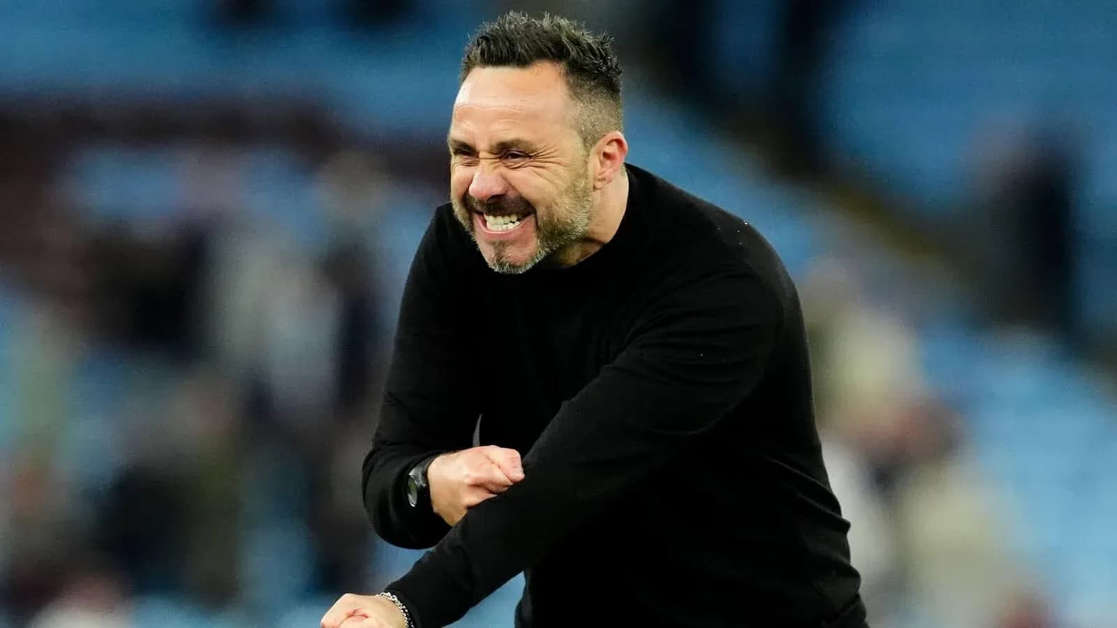 Coach celebrating during a match at the stadium