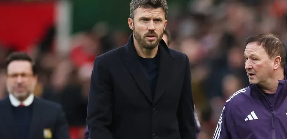 Coach walking alongside staff during match
