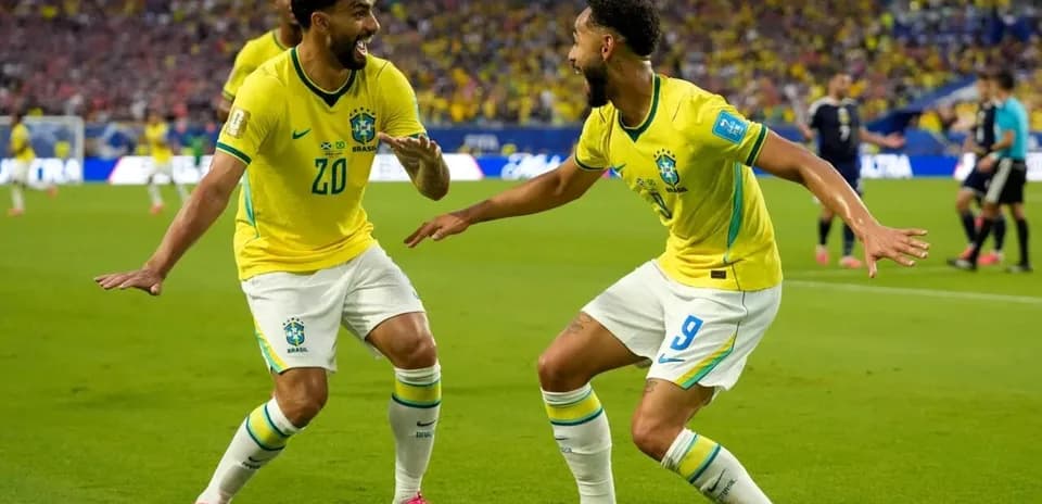 Two Brazil players celebrating a goal on field