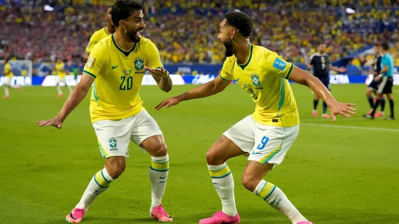 Two Brazil players celebrating a goal on field