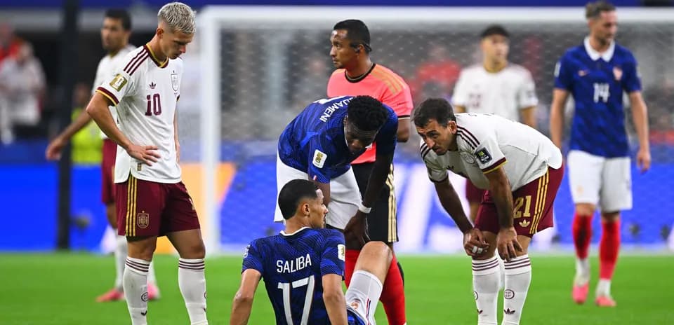 Players attending to injured player on the field