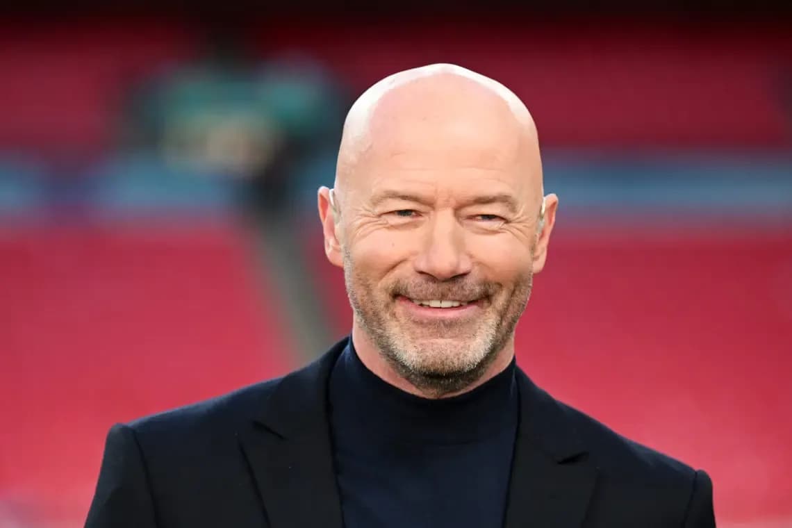 Bald man smiling in a sports venue