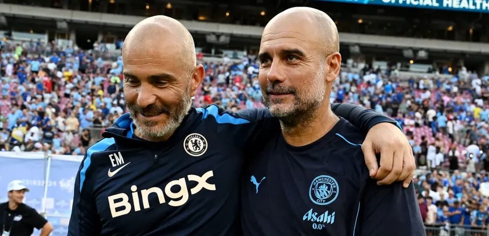 Two coaches celebrating after a match on the field