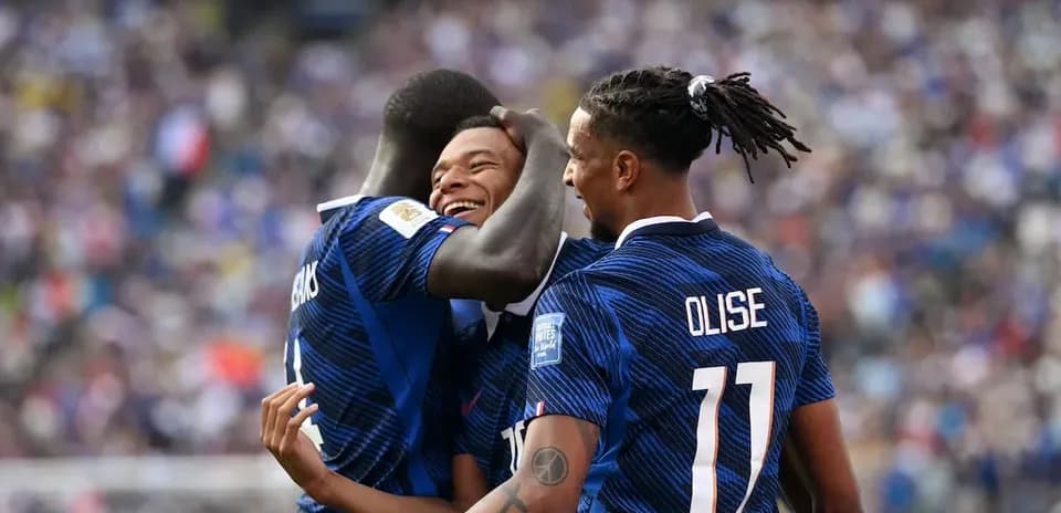 Three players celebrating a goal during match