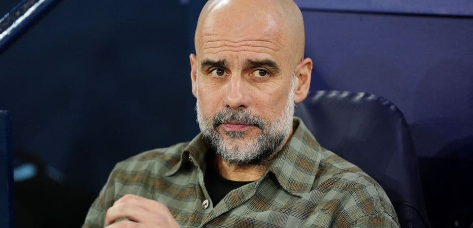 Manager seated during match, looking focused