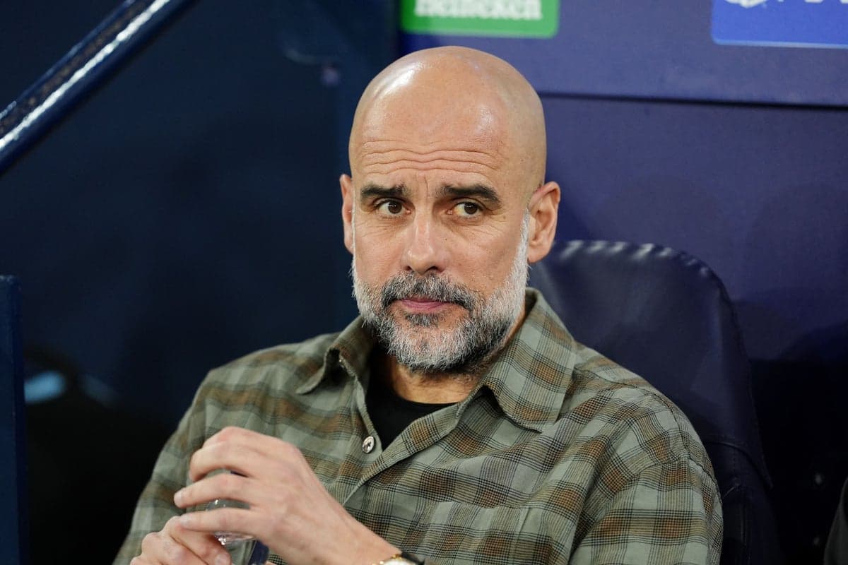 Manager seated during match, looking focused
